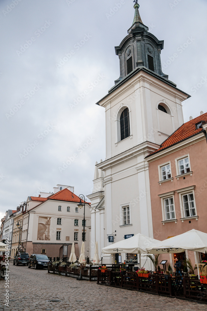 Warsaw, Poland, 13 October 2021: St. Hyacinth's Church with bell tower in New town, founded by Dominican Order and adjoins largest monastery, Renaissance and early-Baroque styles at sunny day