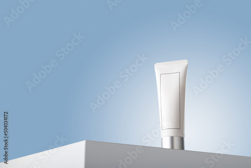 White no brand tube template on table, blue backdrop. Hair care balm, conditioner, natural cosmetics mock up container. No label, copy space