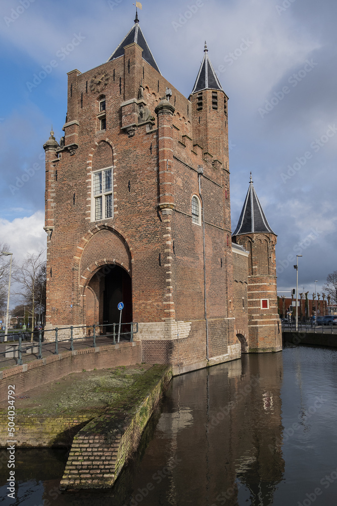 Amsterdamse Poort (or Spaarnwouder Poort, 1355), old city gate of Haarlem. The brick gate with towers is at the end of old route from Amsterdam to Haarlem. Haarlem, North Holland, the Netherlands. Amsterdamse Poort (or Spaarnwouder Poort, 1355), old city gate of Haarlem. The brick gate with towers is at the end of old route from Amsterdam to Haarlem. Haarlem, North Holland, the Netherlands.