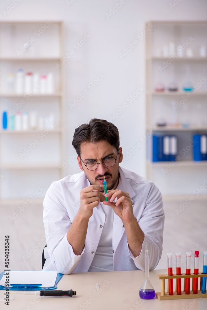 Young male chemist working at the lab Young male chemist working at the lab