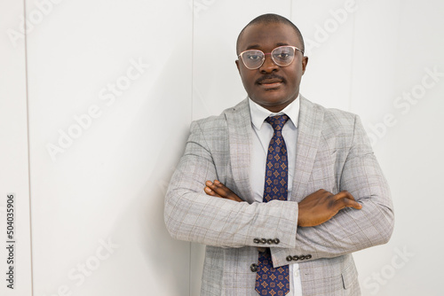 portrait of a successful african businessman with glasses in a suit photo