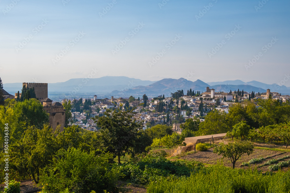 Aerial view of the city with historic center of Granada with some part of Alcazaba castle and Sierra Nevada on background