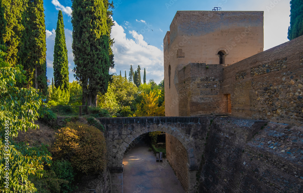 Beautiful Arabian arches bridge between green gardens of the Alhambra
