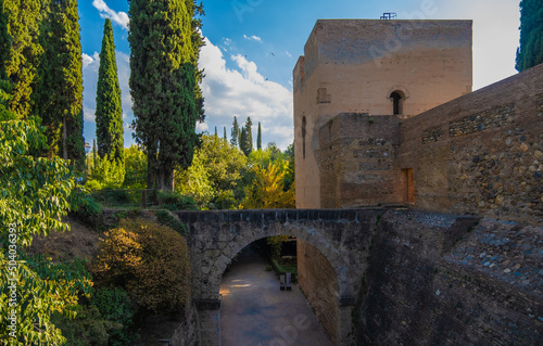 Beautiful Arabian arches bridge between green gardens of the Alhambra