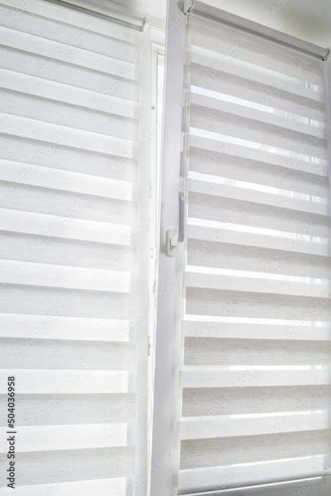 Window roller duo system day and night. Close up on roll curtains indoor. Window roller duo system day and night. Close up on roll curtains indoor.