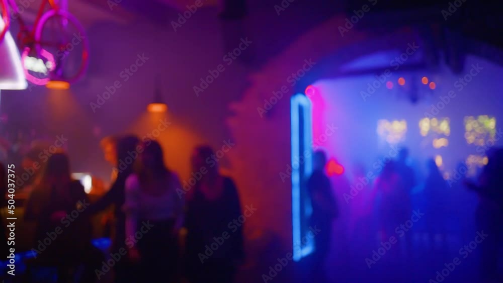 Blurry: Many happy people partying and in a nightclub and walking around with glasses of aclohol Blurry: Many happy people partying and in a nightclub and walking around with glasses of aclohol