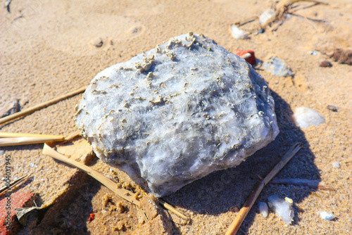 large gypsum stone on the sand close-up