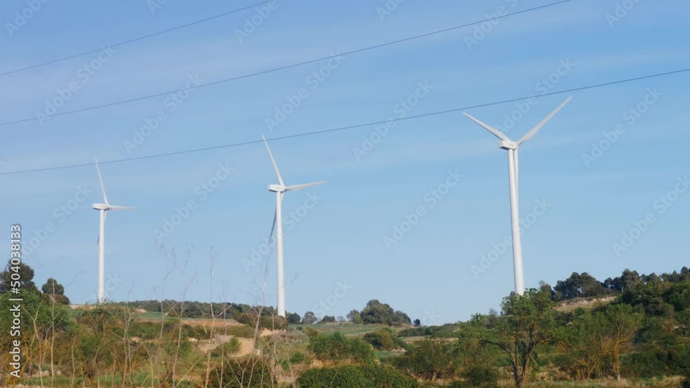 Windmill farm, wind electro eco energy, turbines on blue sky background on european pyrenees mountains. Windmill farm, wind electro eco energy, turbines on blue sky background on european pyrenees mountains.