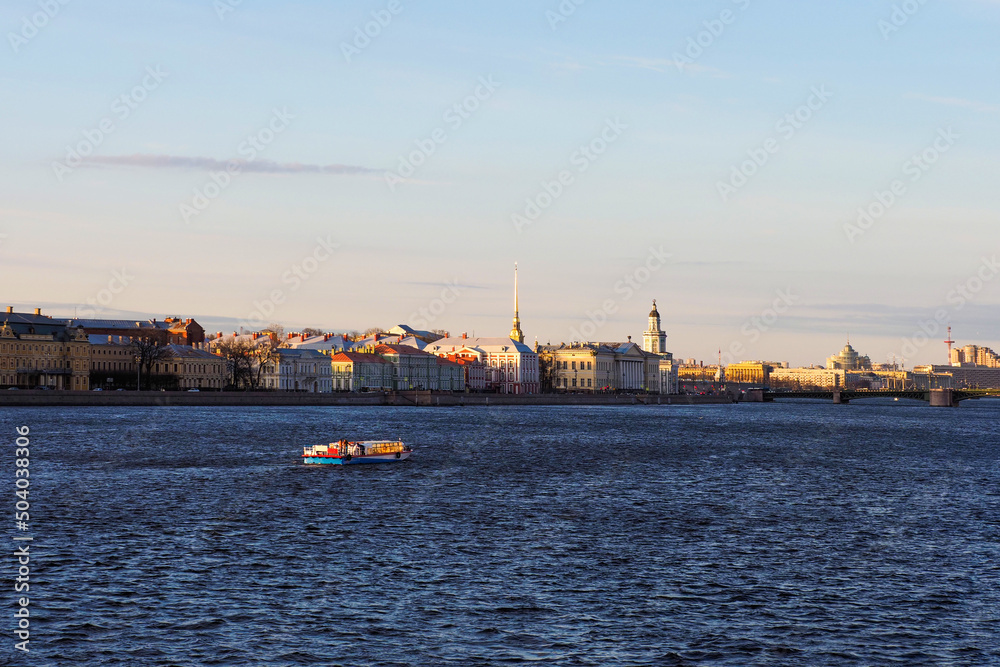 University Embankment of the river Neva, Kunstkamera, Peter and Paul fortress in sunny evening in St. Petersburg, Russia