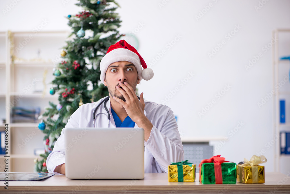 Young male doctor celebrating Christmas at the hospital