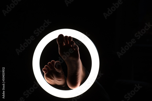 female legs close-up in a round lamp.the concept of hygiene and care.foot fetishism.