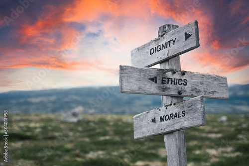 dignity ethics morals text quote caption on wooden signpost outdoors in nature. Stock sign words theme.