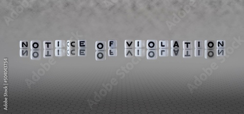 notice of violation word or concept represented by black and white letter cubes on a grey horizon background stretching to infinity photo