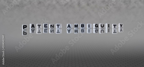patent ambiguity word or concept represented by black and white letter cubes on a grey horizon background stretching to infinity