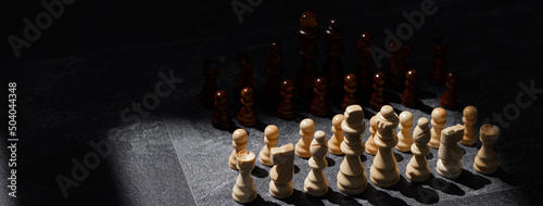 Foto Chess set on the chess board business concept with blur image background