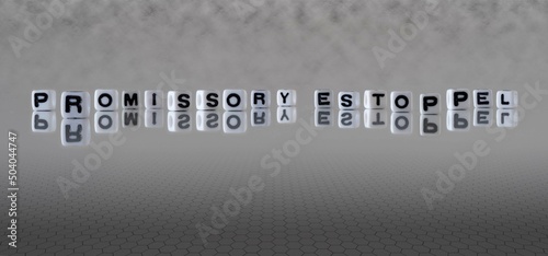 promissory estoppel word or concept represented by black and white letter cubes on a grey horizon background stretching to infinity photo