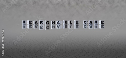Fotografie reasonable care word or concept represented by black and white letter cubes on a