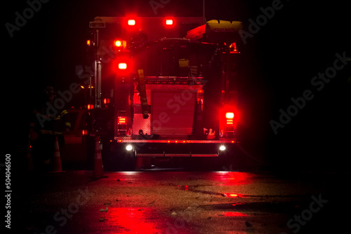 Fire truck and firefighter at night natural gas emergency