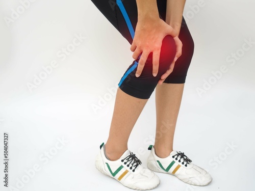 Joint knee pain, arthritis and tendon problems. a woman touching knee at pain point on white background.