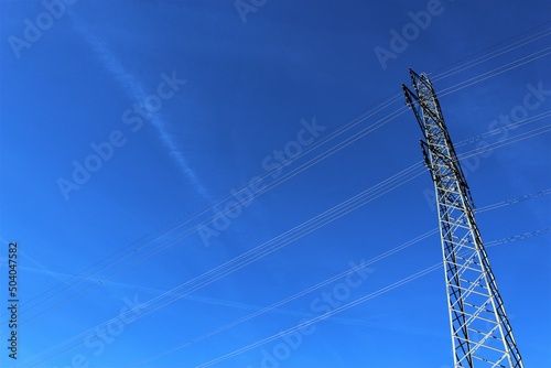 Obraz na plátně Electricity pylon on a sunny day against a clear blue sky (Switzerland)
