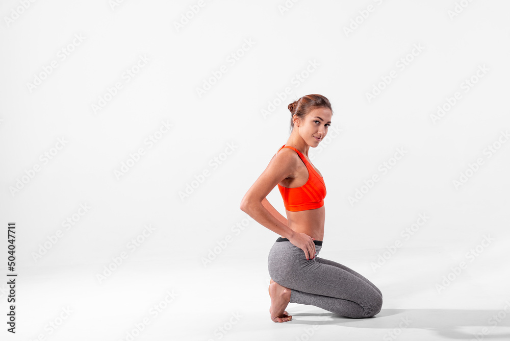 The girl in a tracksuit leaned on her knees, and is ready to do the exercises. The girl in a tracksuit leaned on her knees, and is ready to do the exercises.