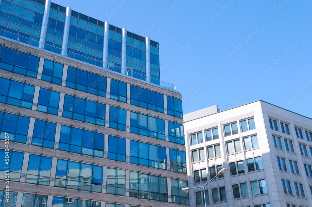 Low angle view of modern buildings on sunny day
