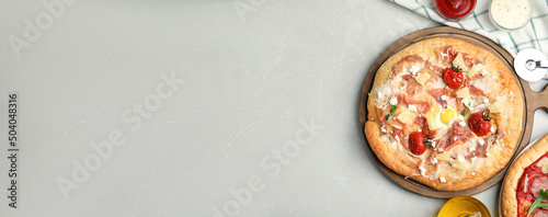 Delicious homemade pita pizza on light marble table, flat lay with space for text. Banner design