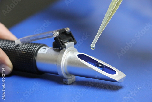 drop of urine about to fall into a Clinical Pet Urine Refractometer photo