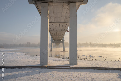 snow-covered bridge over the river in the winter in the sunrise Russia, Krasnoyarsk Vinogradovsky Bridge or Vantovy Bridge photo