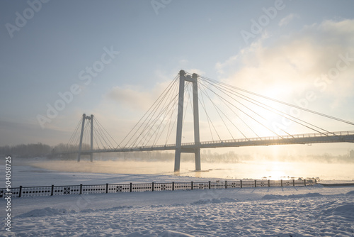 snow-covered bridge over the river in the winter in the sunrise Russia, Krasnoyarsk Vinogradovsky Bridge or Vantovy Bridge photo