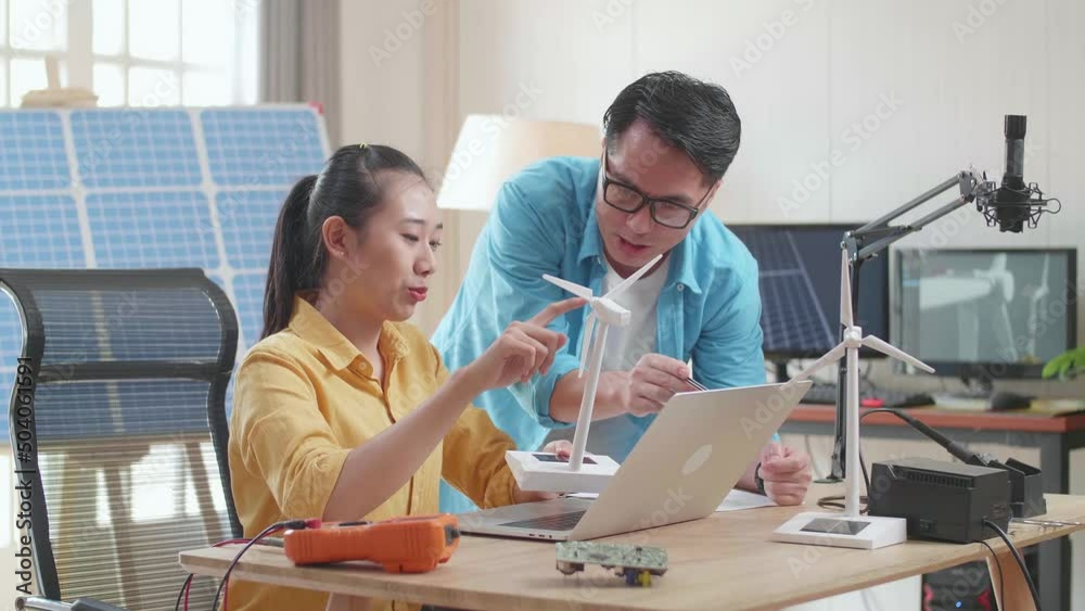 Asian Man And Woman Discuss About Work With Wind Turbine And Laptop Computer
Asian Man And Woman Discuss About Work With Wind Turbine And Laptop Computer