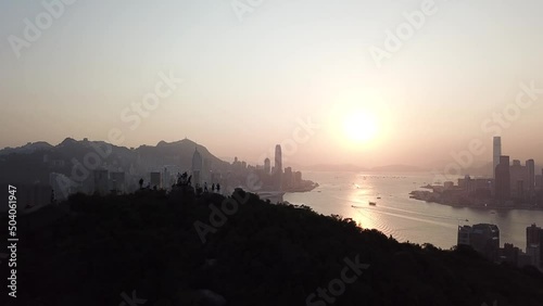 Hong Kong Victoria Harbour sunset with hiker on the mountion photo