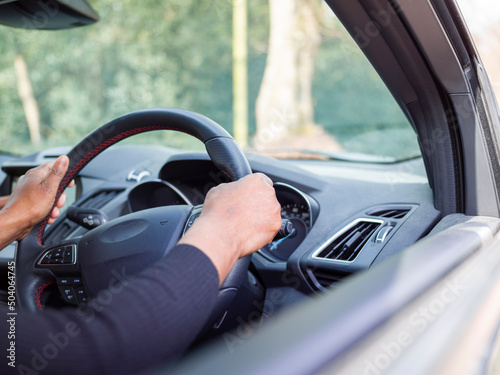 Woman driving car, view of hands