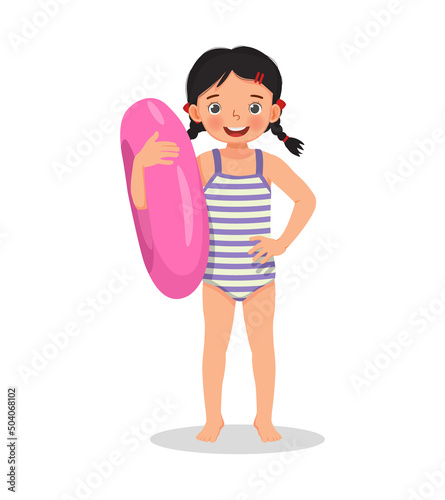 little girl with swimsuit holding inflatable swim ring having fun on summer time