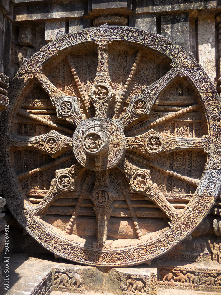 The famous stone chariot wheel engraved in the walls of historic Sun temple in Konark (Odisha, India), a world heritage site.