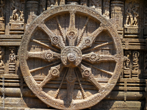 The famous stone chariot wheel engraved in the walls of historic Sun temple in Konark (Odisha, India), a world heritage site. photo