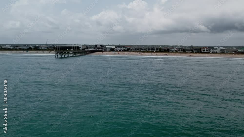 Drone flying over Wrightsville Beach moving towards the pier and the land of sand. Drone flying over Wrightsville Beach moving towards the pier and the land of sand.