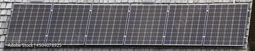 A close up banner of Solar Panel cells on a house roof.
