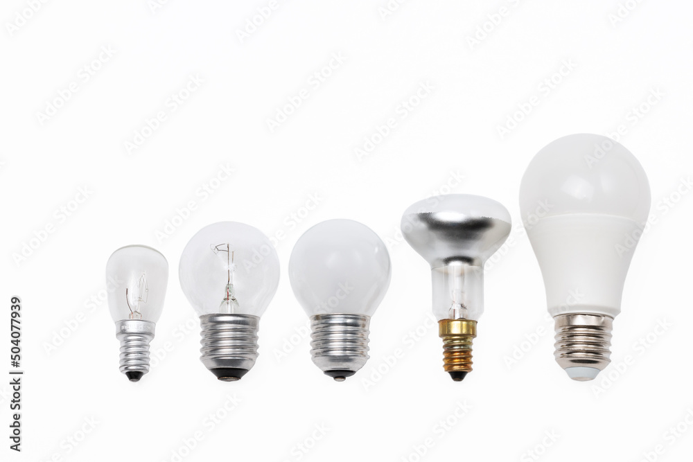 Electric light bulbs models with screw connection lined up on white background Electric light bulbs models with screw connection lined up on white background