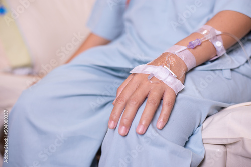 Canvastavla Hands patient woman receiving saline solution during sitting on sick bed at hosp