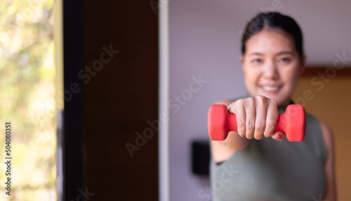 Asian woman exercise with lifting dumbbell at home,Personal workout,Routine plans exercises