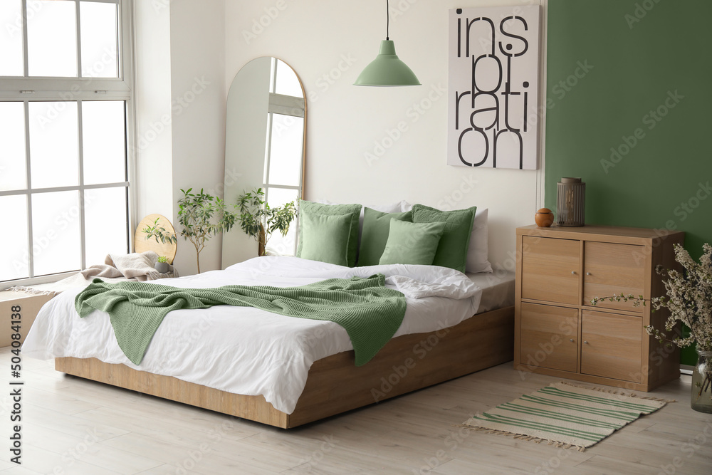 Interior of stylish room with big bed and mirror - obrazy, fototapety, plakaty 