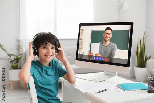 Little boy studying online ...