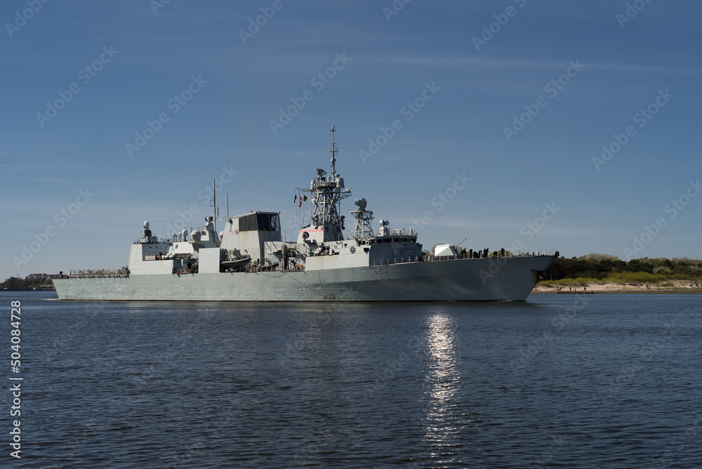 BALTIC SEA - POLAND - 2022: A Canadian Navy frigate sails on on the background of coast