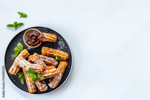 Churros fried pastry with chocolate sauce. Street food dessert