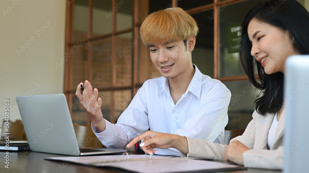 Two skilled businesspeople discussing on new project together at modern workplace. Two skilled businesspeople discussing on new project together at modern workplace.
