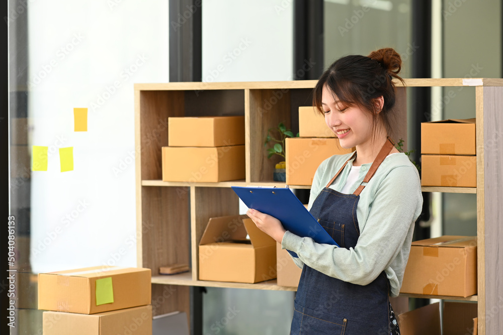 Small businesses owner in apron working at drop shipping business office. Small businesses owner in apron working at drop shipping business office.