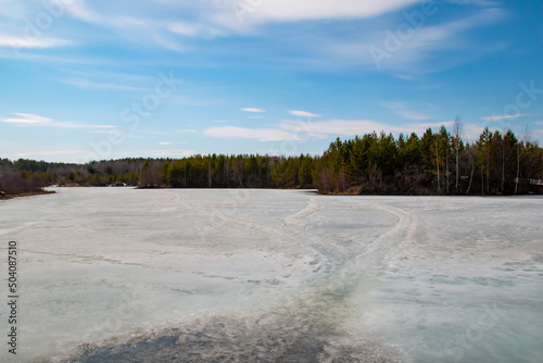 A lake in the Krasnoturinsk region. Spring ice on a lake in the Sverdlovsk region. photo