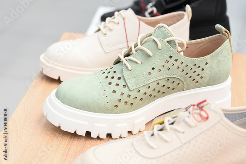 Close-up of women's shoes with thick soles in casual style. Comfortable leather lace-up shoes