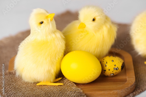 Cute chickens and Easter eggs on light table